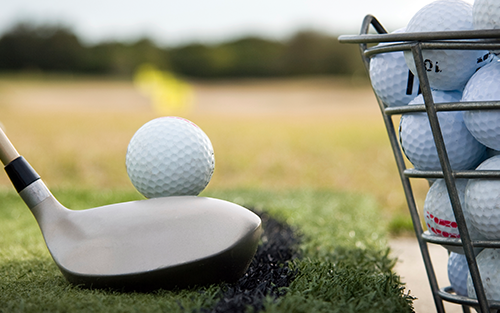 golfer lining up shot at the driving range